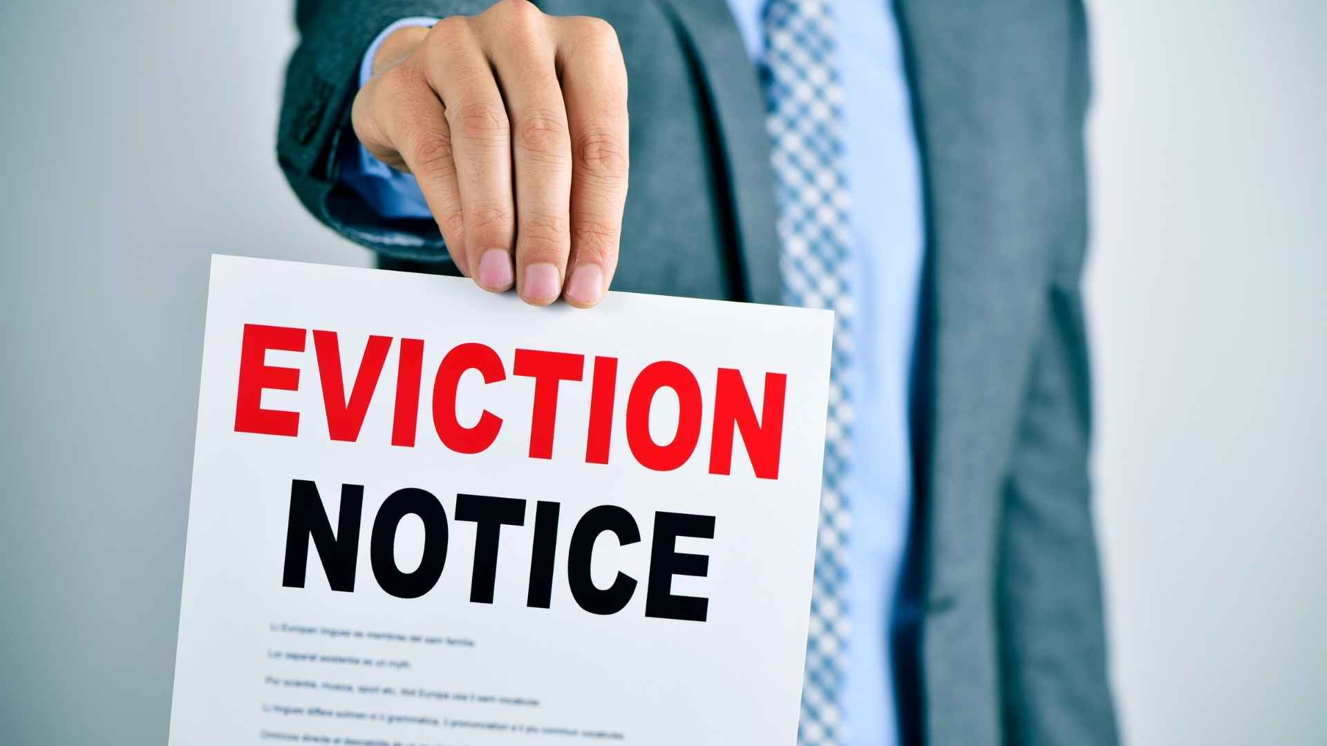 person holding up an eviction notice